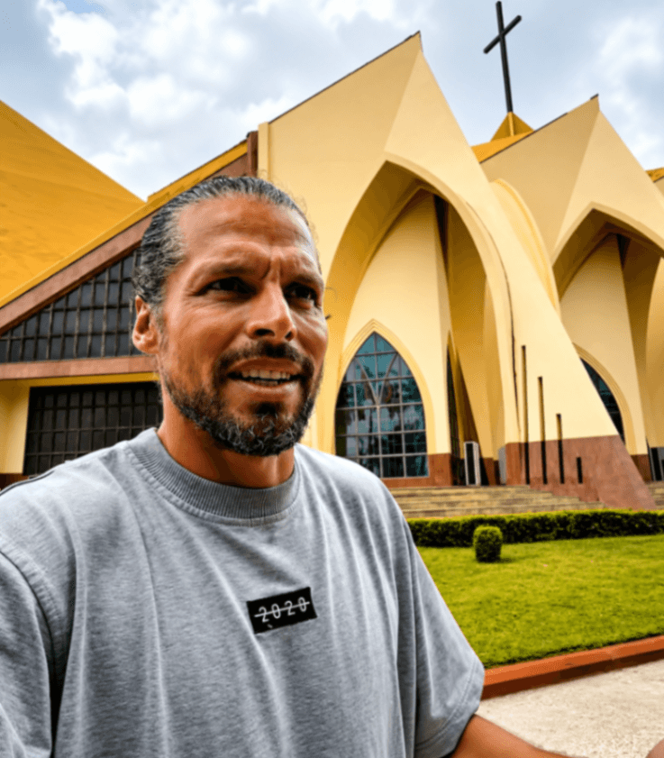 Travel vlogger visiting a church in Abuja and experiencing its entry protocol.
